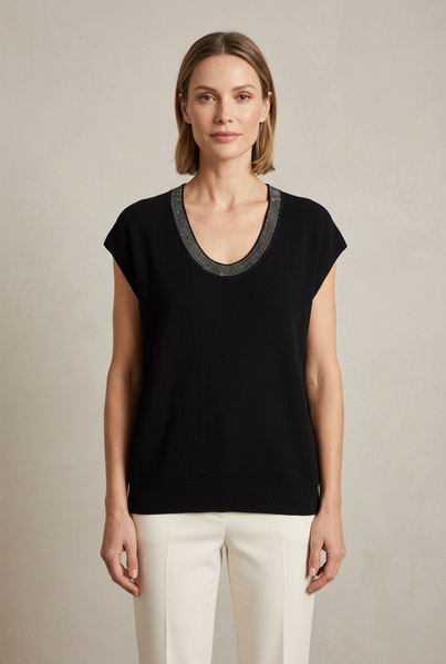 Model wearing a black top with silver-tone sparkle trim around the scoop neckline