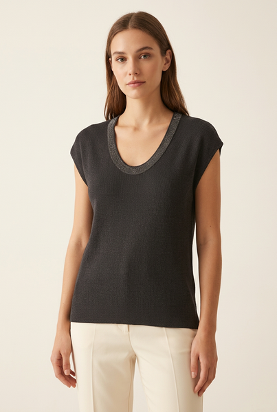 Model wearing dark charcoal shimmer trim scoop neck knit top with cream trousers