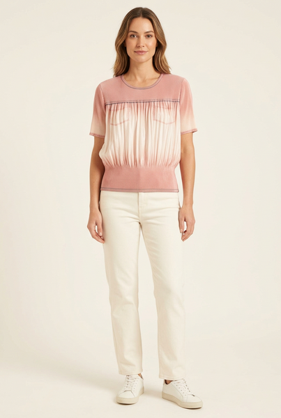 Model wearing a short pink and pale blush ombre pleated top with chest pockets and ivory trousers