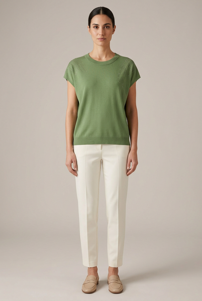 AI-generated full-body model wearing a green knit top with sparkling shoulder embellishments and ivory trousers