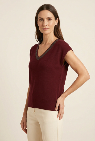 Model wearing maroon shimmer trim scoop neck knit top in a three-quarter pose