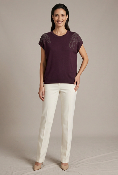 AI-generated full-body model in a three-quarter pose wearing a purple shoulder-embellished knit top with ivory trousers