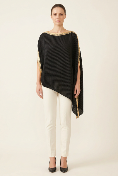 AI-generated model wearing a black diagonally pleated draped top with gold chain-pattern trim and ivory trousers