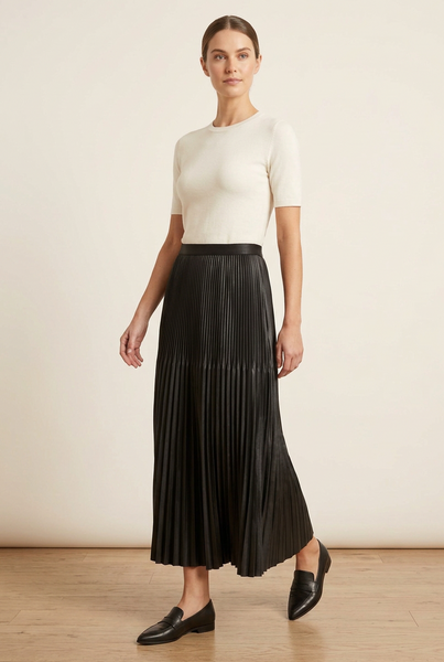 Model wearing the black accordion pleated skirt in an alternate pose.