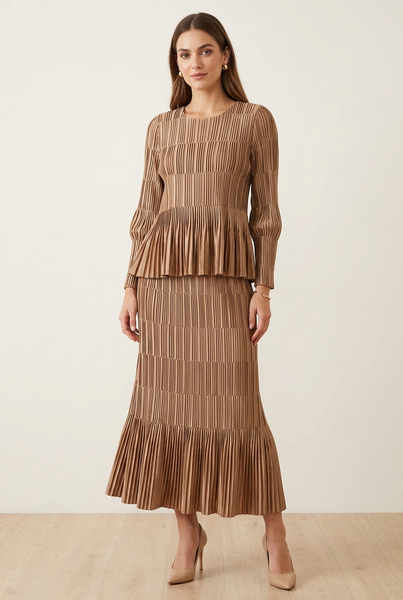 AI-generated model wearing a bronze pleated long-sleeve top and matching long skirt co-ord set