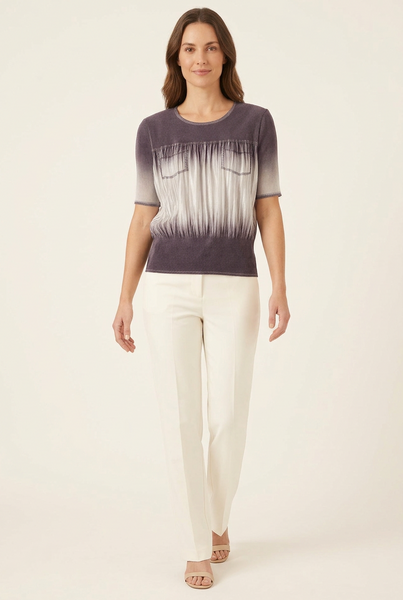 Full-body model wearing a short purple and silver-grey ombre pleated pocket top with ivory trousers and beige sandals