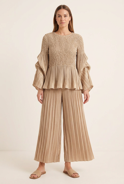 Model wearing the matching beige textured top and pleated wide-leg pants