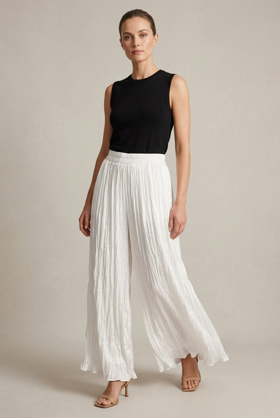 AI-generated full-length model wearing white crinkle-textured wide-leg pants, a black top and neutral heels